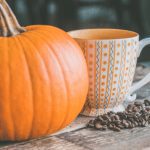 Pumpkin next to a cup of coffee