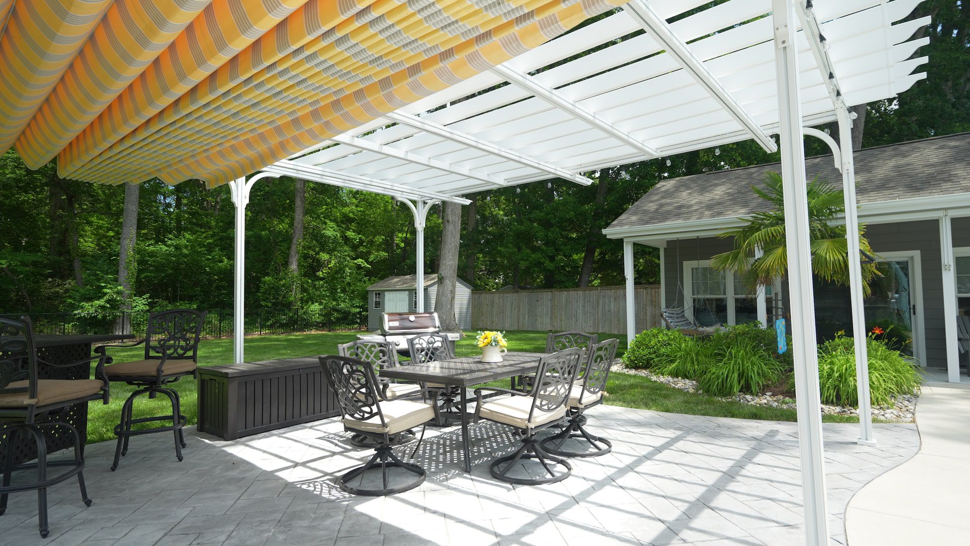 Pergola Canopy slightly extended over patio dining set - ECCO Sunroom & Awning