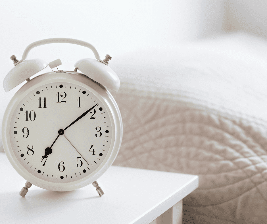 alarm clock beside bed in sunroom | Ways to Use A Sunroom