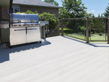 Enclose a deck with glass walls and make it waterproof with aluminum decking. Finish with aluminum railing and sconce lights by Craft-Bilt.