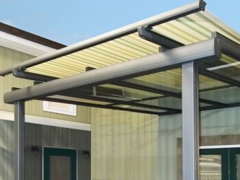 Mounted over a glass roof, this tension shade structure reduces temperatures and creates shade.