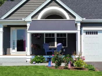 Gray motorized awning over front porch front view