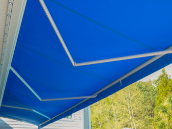 Large blue motorized awning underside view