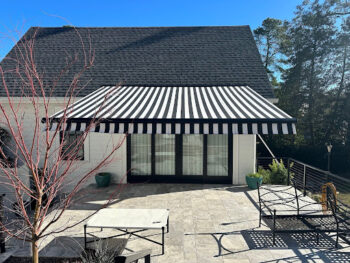 Black and white striped motorized awning