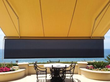 Almond motorized awning extended with drop screen underside view