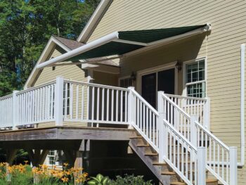 Motorized awning extended side view over deck full cassette